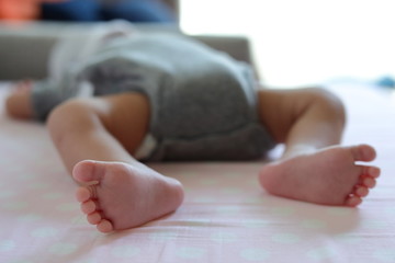 Obraz na płótnie Canvas cute little baby newborn barefoot