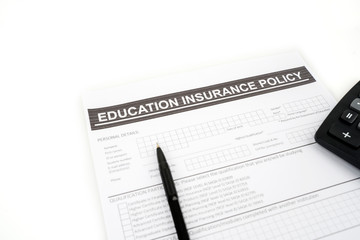 Education insurance policy document beneath a pen