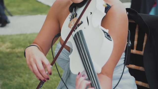 Woman violonist playing in slow motion