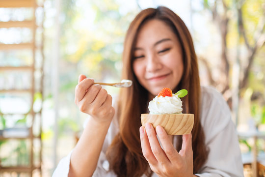 Closeup Image Of A Beautiful Asian Woman Enjoy Eating An Ice Cream In Restaurant