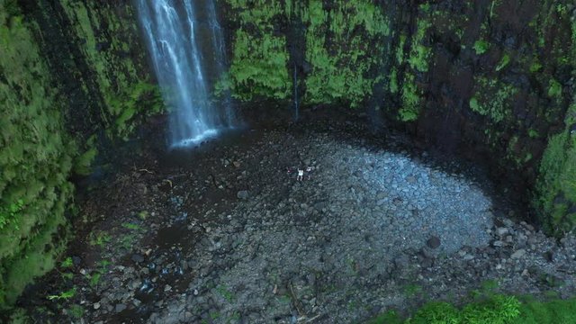Drone hovering over turists in waterfall in Maui, Hawaii