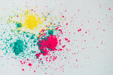 Abstract multicolor powder mixed on white background. Freeze motion of color powder. Concept Indian festival Holi.