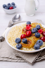 Wheat porridge with fruit and berries