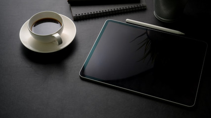 Cropped shot of workspace with digital tablet, office supplies and coffee cup