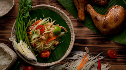 Top view of Somtum, Thai traditional food with chicken grilled, ingredients  and sticky rice