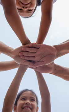 Asian family standing hands support together. Family generation join hands showing unity and teamwork.