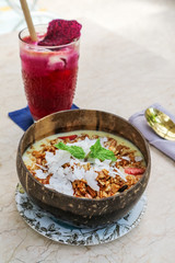 Smoothie bowl with mango, yogurt, granola and strawberry