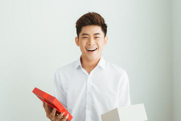 Cheerful young man in present boxes.