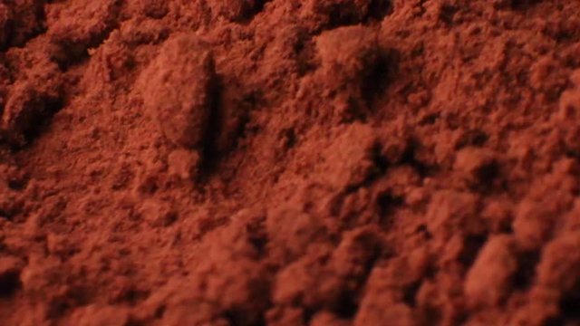 Details of cacao or coffee under a microscope. Extreme closeup of a cacao powder isolated on white background. Macro footage reviewing parts in cacao.