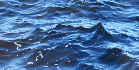 Waves on blue water surface, natural background 