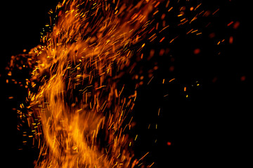 Fototapeta na wymiar flame of fire with sparks on a black background