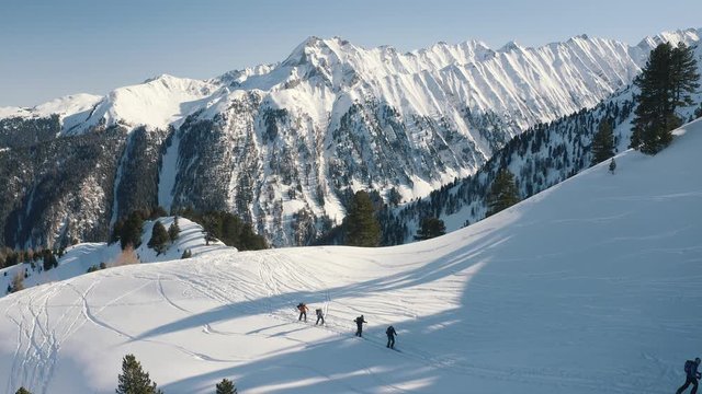 People splitboarding up the slopes in the back country. Mountain lanscape. Zillertal, Austria