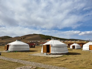 Fototapeta na wymiar Mongolia Field Plains Sky Nature Scenery and a traditional house
