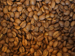 Background image of many coffee beans filling the picture
