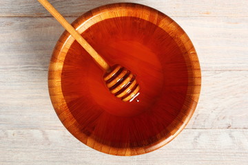 Honey with Honey Dipper in Wooden Bowl