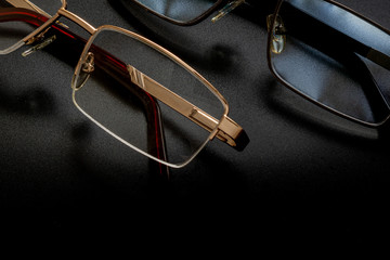 Fragment of glasses on a texture dark background