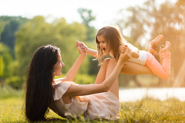 Obraz premium Adorable daughter playing with her mom