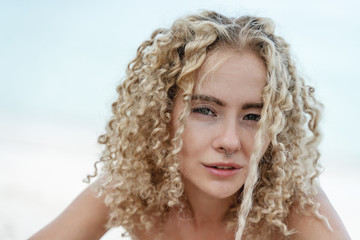 Fototapeta premium Head portrait shot, young beautiful curly sexy blonde, beauty and fashion, trendy hair style