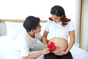 Young man taking care of young wife while pregnant