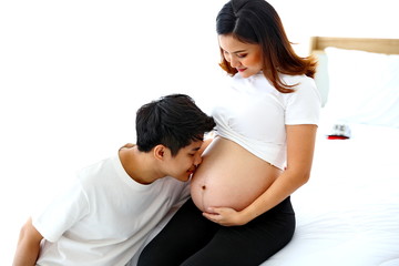 Young man taking care of young wife while pregnant