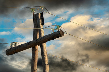 Old electricity pylon cables on wooden poles, high voltage post or high voltage tower. Engineering...