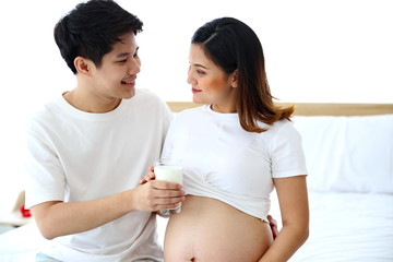 Young man taking care of young wife while pregnant