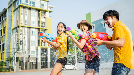 Asian people are using water guns play songkran festival in the summer april