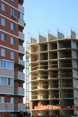 Tower cranes are working on the construction of a new house. Lifting crane.