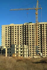 Tower cranes are working on the construction of a new house. Lifting crane.
