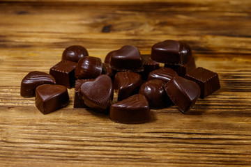 Tasty chocolate candies on wooden table