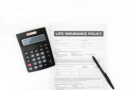 Top down of insurance document near a calculator