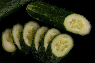Cucumber slices against black background	