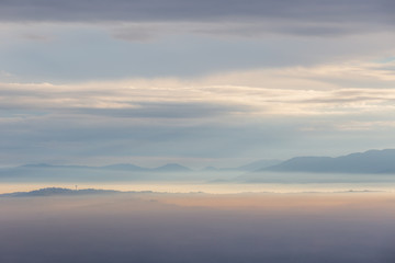 Fototapeta na wymiar Sea of fog and mist between mountains and hills