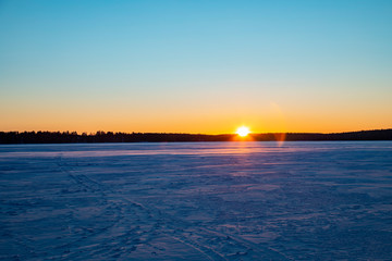 Obraz premium Mystical evening winter landscape. Silhouettes of trees at sunset.