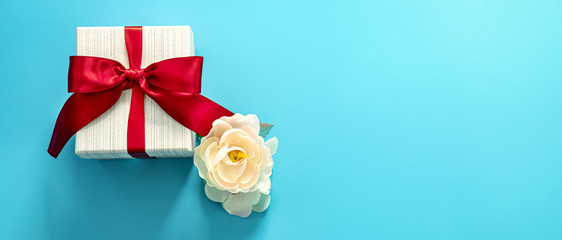  gift box with red bow on a blue background . Happy Father's or Mother's or Women 's  day...