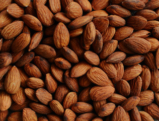 Organic almond nuts as background, top view, close up