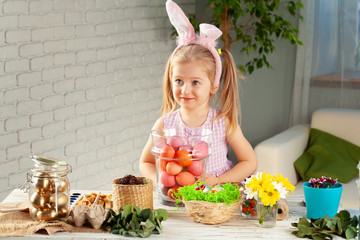 Happy little girl with bunny ears getting ready for Easter party