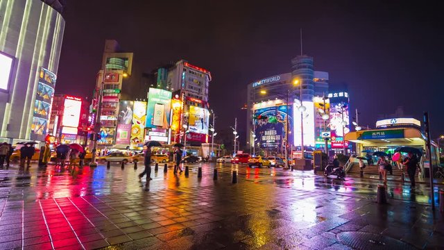 Time-lapse of traffic and people walking on crosswalk in the night at Ximending in Taipei, Taiwan. Ximending is the famous fashion, night Market and street food in Taipei.