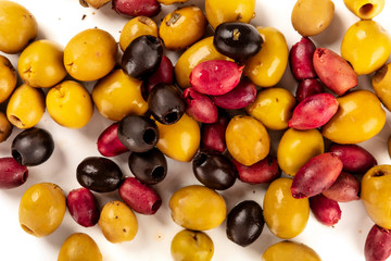 Many different olives, green, black and red, shot from the top on a white background