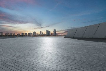 Panoramic skyline and buildings with empty square floor.