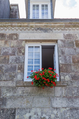 Brick walls background of ancient buildings with windows and flowers