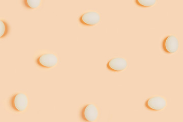 Happy Easter. White eggs on yellow background. Flat lay, top view, copy space.