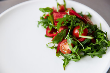 cherry tomato salad with arugula and pepper, healthy eating, copy-space for text