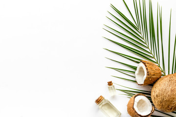 Coconut background with oil on white background top-down copy space