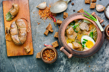 Meat soup in a clay pot