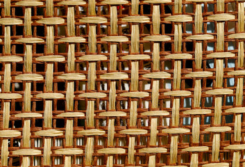 Blurred abstract beautiful straw weave background. Close-up of a surface made of interlaced lines of straw. Natural yellow textured background. Horizontal, closeup, free space, cropped shot.