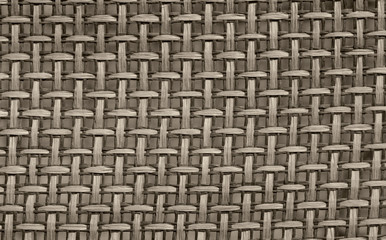 Blurred abstract beautiful straw interweaving background. Close-up of a surface made of interwoven straw lines. Natural textured background. Horizontal, closeup, free space, cropped shot, gray toning.