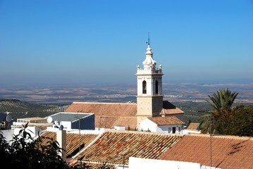 San Sebastian parish church (Iglesia Parroquial de San Sebastian) with view over rooftops towards countryside, Estepa, Spain.