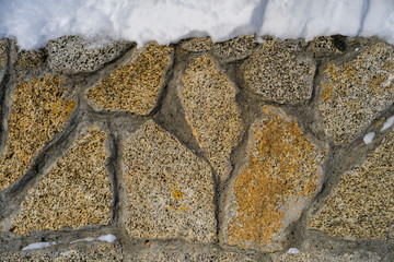 Granite fence under the snow. Close up.