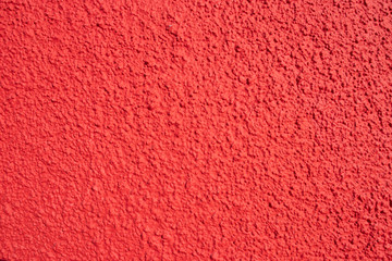 Textured grunge red wall background of a building